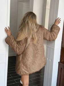 Back view of a long brown faux fur coat showing thick fluffy texture and elegant fit