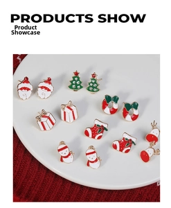 Detailed set of 7 pairs of Christmas earrings with Santa and reindeer motifs on a tray