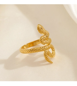 Macro shot of gold snake ring featuring detailed scales texture on a silk background