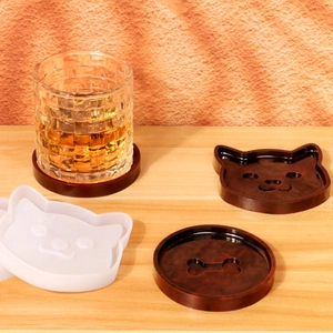 Cat head and bone shape silicone coaster mold with finished resin products on wood table