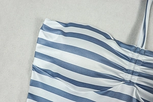 Detail of blue and white striped romper featuring center ruching and thin shoulder straps