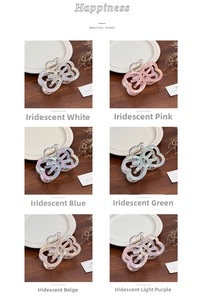 Close-up of heart-shaped iridescent acrylic hair claws in six soft pastel colors