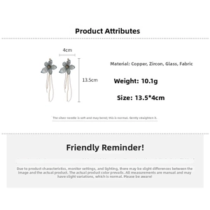 Detailed size and weight view of blue fabric flower earrings with crystal tassels