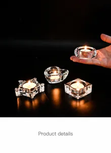 Macro shot of clear glass tea light holders in heart and star shapes on a black surface
