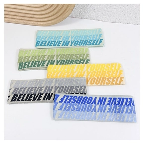 Close-up of five knitted elastic sports headbands in various colors with text pattern