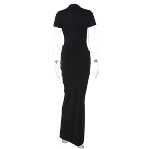 Rear view of sleek black short sleeve maxi dress with elegant drape on a clear mannequin