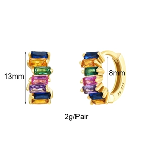 Macro detail of Ag 925 gold-plated huggie earrings with colorful zircon stones
