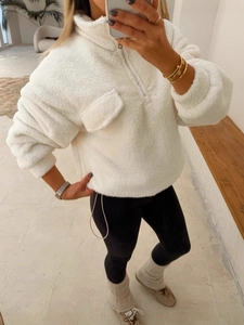 Women's white fleece half-zip pullover jacket with chest pocket in a stylish loose fit