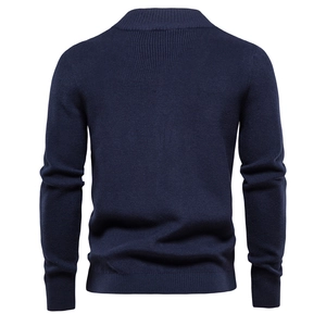 Detail view of the navy blue knit cardigan back with ribbed cuffs and high quality texture