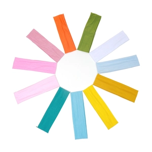 Set of 12 colorful elastic yoga headbands in diverse vibrant colors on a white background