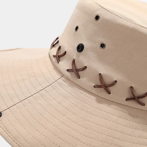 Detail of khaki outdoor hat showing metal air vents and brown braided rope trim