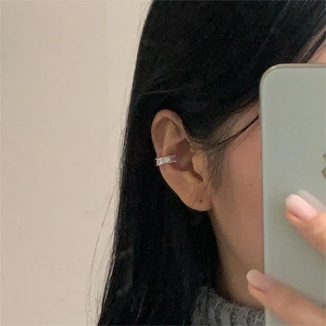 Mirror selfie showing a silver ear cuff with rectangular zircons on the ear cartilage