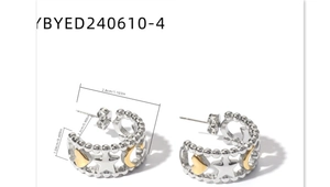 Detail view of two-tone hoop earrings with hollow star and heart patterns and size specs