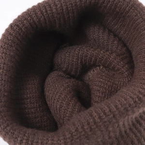 Deep brown knitted beanie hat featuring a thick ribbed texture for winter warmth