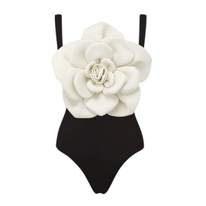 Detail of elegant black swimsuit featuring a large white 3D camellia floral decoration