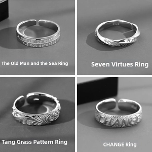 Detail view of four silver rings with Old Man and the Sea quotes and engraved patterns