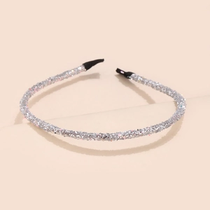 Close-up of glitter silver headband with shimmering sequins and protective black end caps