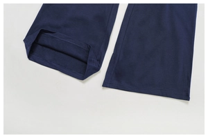 Detailed close-up of navy blue sports pants hem showing high-quality stitching and fabric