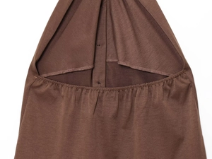 Detail view of brown pleated top waist with elastic smocked design and smooth knit texture