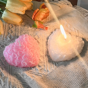 Handcrafted rose embossed heart candles in pink and white for romantic decor