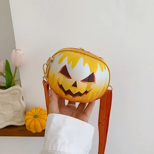 Detail of a 3D spherical pumpkin crossbody bag with a wide patterned shoulder strap