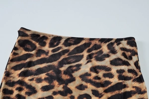 Detailed macro view of leopard print mesh fabric texture and waistline stitching