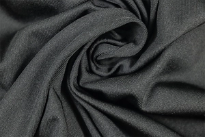 Macro shot of high-quality black knitted fabric texture with fine fiber details