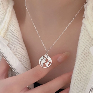 Close-up of 925 sterling silver hollow globe world map pendant on a thin chain