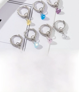 Detail shot of heart-shaped zircon hoop earrings in assorted vibrant colors and silver finish