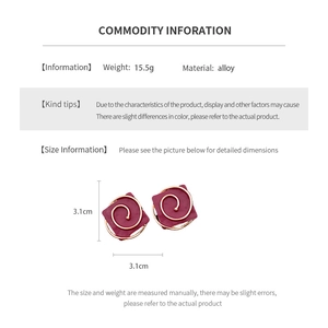Detailed view of 3.1cm wine red square earrings with golden spiral design in alloy