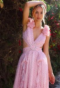 Detail of pink floral dress featuring ruffles, waist cutout, and circular ring detail
