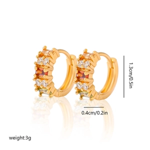 Detail view of 1.3cm gold hoop earrings with orange square zircon and clear crystals