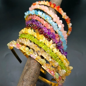 Handmade golden crowns with multi-colored natural crystal stones on a branch