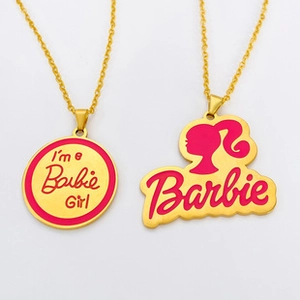 Close-up of Barbie-themed gold necklaces with pink pendants and engraved silhouettes
