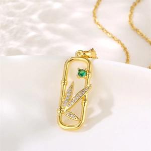 Elegant 18K gold bamboo leaf necklace pendant with green gemstone and zircon accents