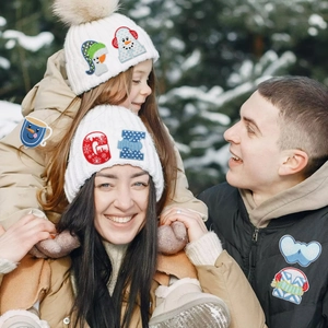 Winter themed embroidered letter patches with cartoon snowmen on warm knitted hats