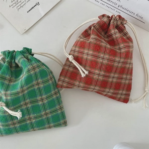 Close-up of red and green plaid drawstring pouches in cotton linen with thick cords