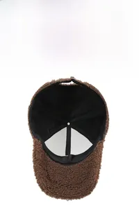 Detail of warm brown teddy fleece baseball cap showing breathable mesh inner lining