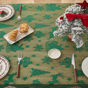 Detail der grünen Weihnachts-Tischdecke aus Spitze mit Rentier- und Schneeflockenmustern