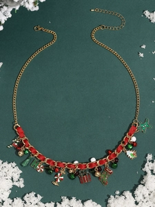 Detail of Christmas necklace with red ribbons, gingerbread man and gift charms