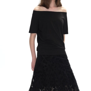 Detailed view of black off-shoulder short sleeve T-shirt paired with matching lace skirt