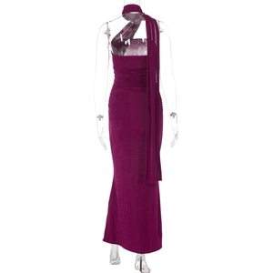 Back view of magenta velvet long evening gown featuring halter neck and flowing streamers