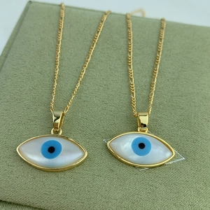 Detail of evil eye marquise mother of pearl pendant necklaces on green velvet box