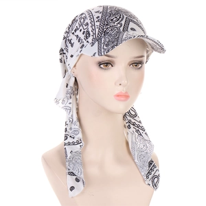 Detail of black and white paisley headscarf cap with brim and adjustable straps