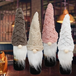 Christmas gnome wine bottle covers in beige pink and white with knitted hats and faux fur beards