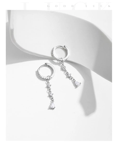 Macro detail of S925 silver U-shape drop earrings with shimmering zircon waterdrop pendant