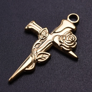 Detailed macro view of 18k gold plated 304 stainless steel cross and rose pendant charm