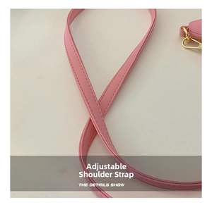 Close-up of adjustable shoulder strap and pink PU leather stitching on the crossbody bag