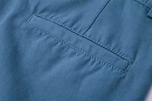 Close-up of blue cotton cargo shorts showing durable double-stitched pocket seams