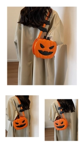 Detail view of pumpkin crossbody bag with bat wing straps worn by a model